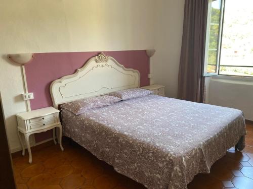 a bedroom with a bed with a white bedspread at Casa Elvira in Imperia