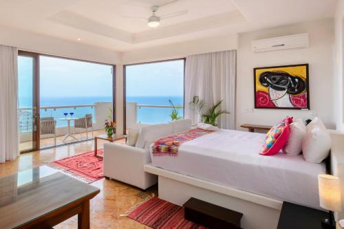 a bedroom with a bed and a view of the ocean at Villa Divina Luxury Boutique - Adults Only in Puerto Vallarta