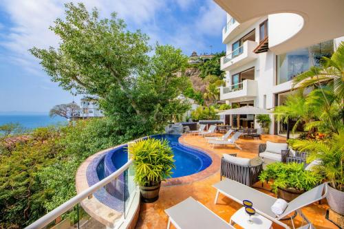 an apartment with a balcony with a swimming pool at Villa Divina Luxury Boutique - Adults Only in Puerto Vallarta