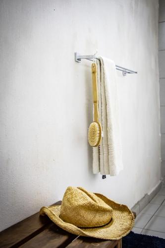 a hat and a towel hanging on a wall at East Africa Safaris in Chizavane
