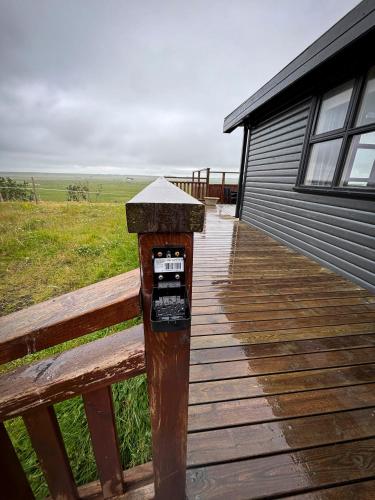a parking meter on a wooden deck next to a building at Áshamrar in Hella