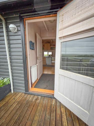 an open door to a porch of a house at Áshamrar in Hella