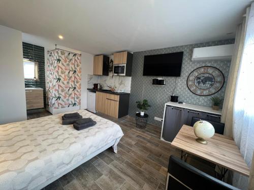une chambre avec un grand lit et une cuisine dans l'établissement Trendy love Balnéo, à Tassin-la-Demi-Lune
