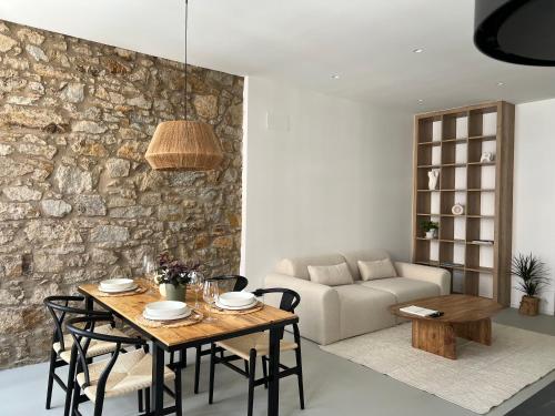 a living room with a table and a couch at Ferrol by Miramar Stays in Ferrol
