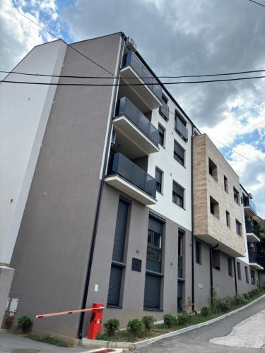 a white building with balconies on the side of it at KIA APARTMENT 2 in Valjevo
