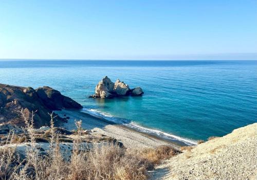 a view of the ocean with rocks in the water at Chariandry Court in Pissouri