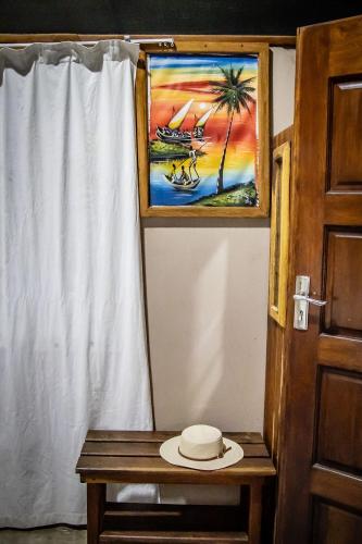 a hat sitting on a table next to a window at East Africa Safaris in Chizavane