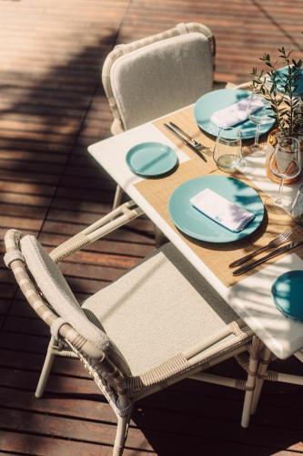 a table with chairs and plates on a deck at Four Seasons Hotel Tunis in Gammarth