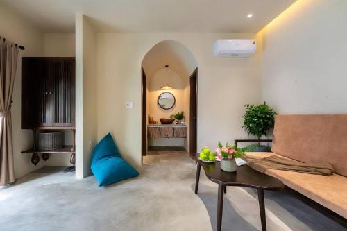 a living room with a couch and a table at Coastal Village An Bàng Hội An in An Bang