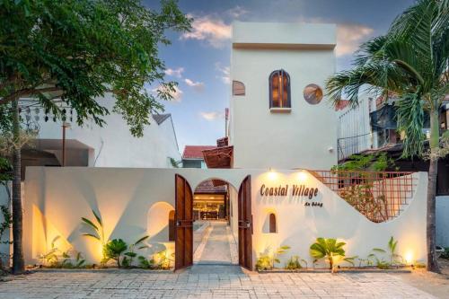 a white building with a sign that reads angel masy at Coastal Village An Bàng Hội An in An Bang