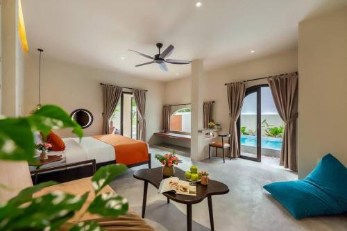 a hotel room with a bed and a pool at Coastal Village An Bàng Hội An in An Bang