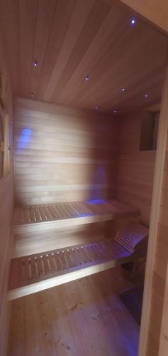 an empty sauna in a room with wooden floors at Aurora Spa in Kunje