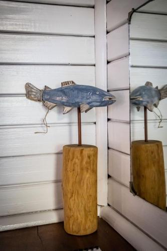 a blue fish on a wall next to a piece of wood at East Africa Safaris in Chizavane