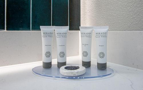 a group of four tubes of makeup on a table at Hotel Elev8 Flagstaff, Trademark Collection by Wyndham in Flagstaff