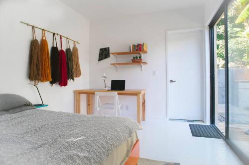 a bedroom with a bed and a desk and a window at Modern architecture with great view in San Agustín Etla