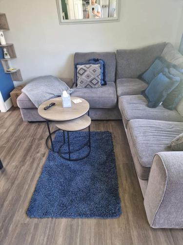 a living room with a couch and a table at 27 bucklands in Bideford