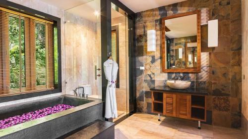 a bathroom with a large tub and a sink at Seaview Villa Yang Som at Surin Beach in Thalang