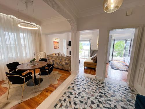 a living room with a table and chairs and a couch at CASA BIANCA Kastoria in Kastoria