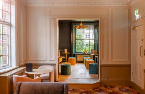 a room with chairs and tables and a window at Milford Hall Salisbury in Salisbury