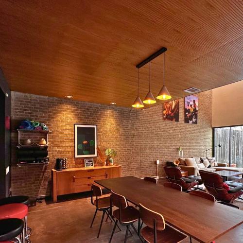 a living room with a large wooden table and chairs at Chic In The City in Houston