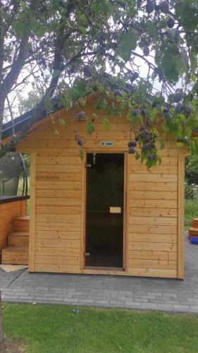 a large wooden building with a door in it at Pod Kalwarią in Nowosiółki Dydyńskie