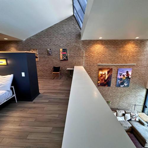 a room with a bed and a brick wall at Chic In The City in Houston
