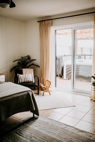 a bedroom with a bed and a sliding glass door at Oakes House in River Charlo