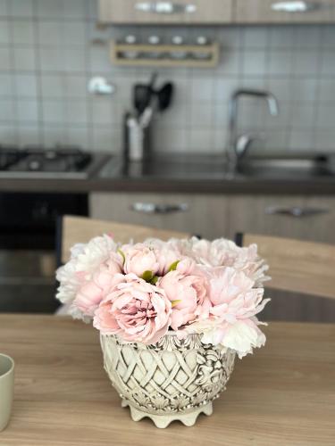 a vase filled with pink flowers sitting on a table at Spacious Studio Apartment with Terrace in Perugia
