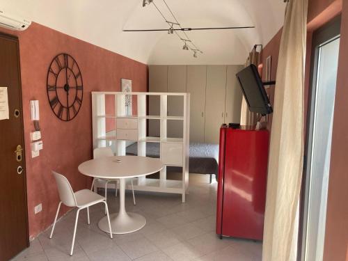 a small room with a table and a red refrigerator at Gerenzano Apartments in Gerenzano