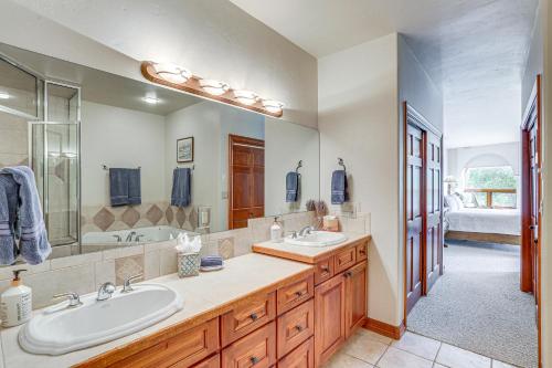 a bathroom with two sinks and a large mirror at Expansive Edwards Condo on Main Street with Views! in Edwards