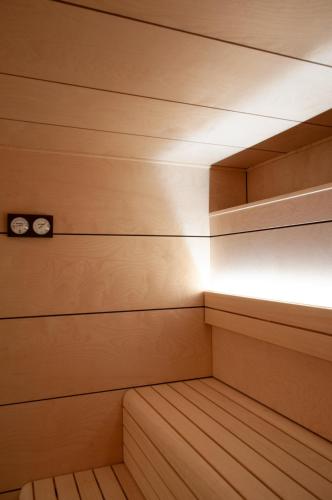 an empty sauna with wooden walls and lights at Hotel Na Taconera in Cala Ratjada