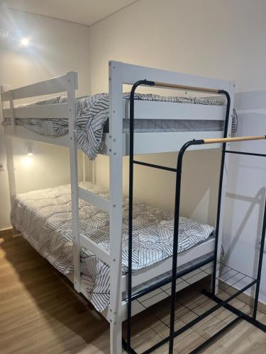 a couple of bunk beds in a room at Friend's House in Maia
