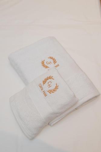 a white towel with a picture of a man on it at Calma Boutique Hotel in Vlorë