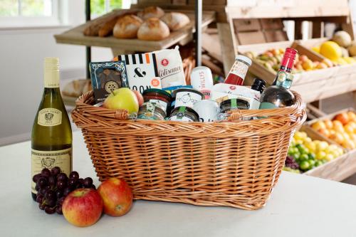 a basket filled with wine and fruit on a table at SCHLOSS Roxburghe, part of Destination by Hyatt in Kelso