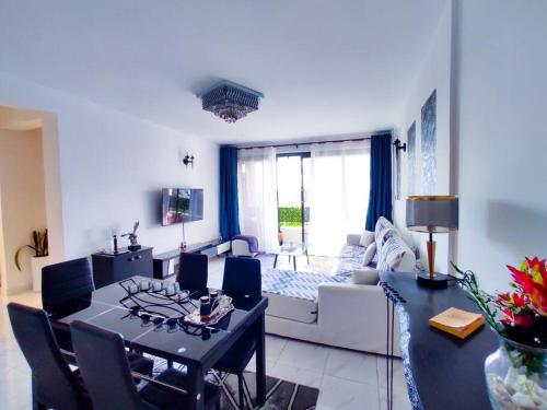 a living room with a table and a dining room at The Crooner Lounge in Nairobi