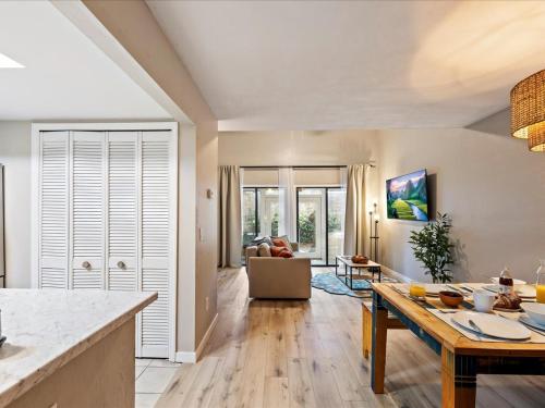 a kitchen and living room with a table at Artist's Tower Townhome Just Renovated w Loft in Gainesville
