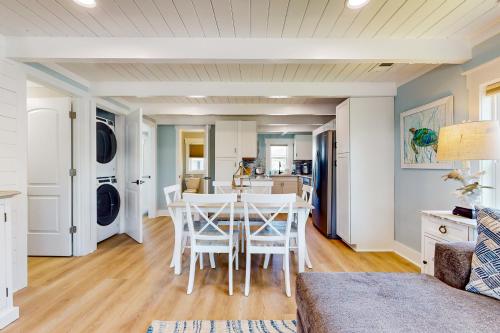 a kitchen and dining room with a table and chairs at Beachside Bungalow in Ocean Isle Beach