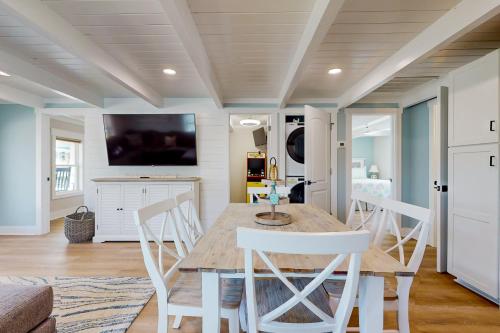 a kitchen and dining room with a table and chairs at Beachside Bungalow in Ocean Isle Beach