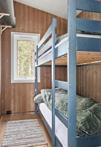 a bunk bed in a room with a window at Tonstad hytta in Tonstad