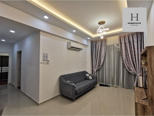 a living room with a chair in a room at Homexuite Vacation at Sri Indah 2 in Sandakan