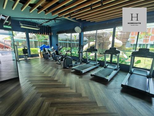 a gym with a row of treadmills and ellipticals at Homexuite Vacation at Sri Indah 2 in Sandakan
