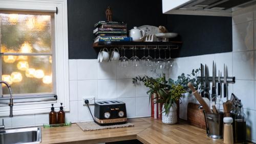 a kitchen with a counter with a sink and a window at Charming Vintage Flat near Newtown. 11am checkout. in Sydney
