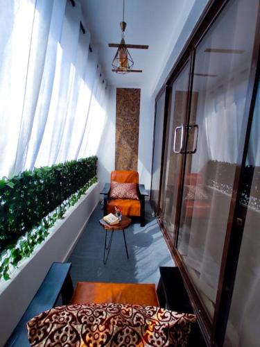 a room with a balcony with a chair and a table at The Crooner Lounge in Nairobi