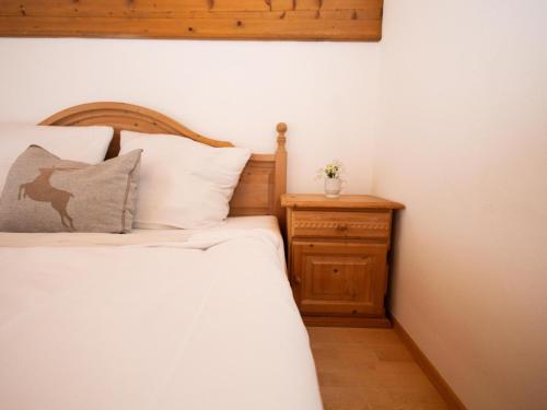 a bedroom with a bed and a night stand at Müller Nr 2 in Kirchberg in Tirol