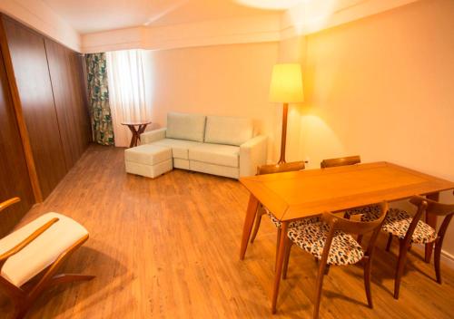 a living room with a table and a couch at Vidam Hotel Aracaju - Transamerica Collection in Aracaju