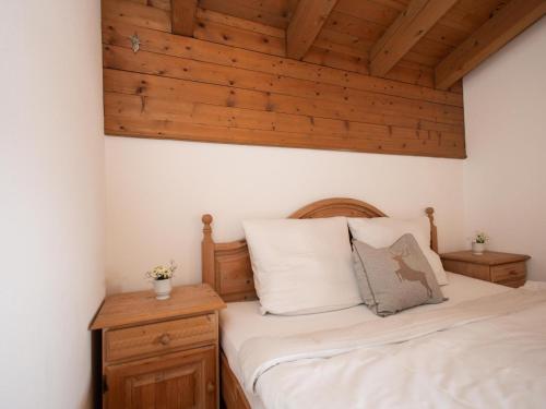 a bedroom with a bed and a wooden ceiling at Müller Nr 2 in Kirchberg in Tirol