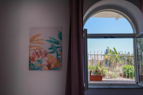 an arched window with a view of a garden at Casa Vacanze Lantana in Ischia