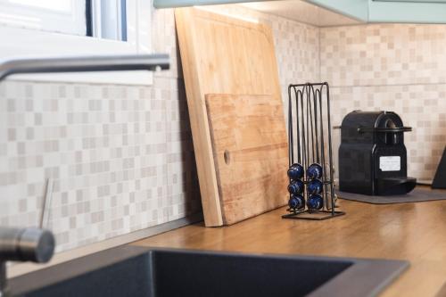 a kitchen counter with a knife block next to a door at Akrotiri Sea View Maisonette in Akrotiri