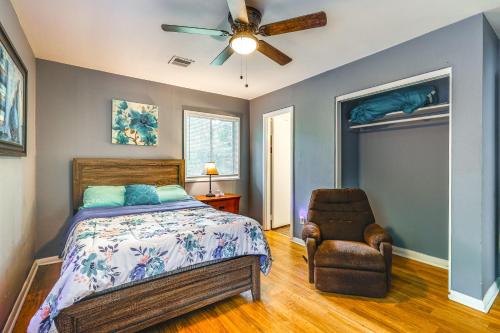 a bedroom with a bed and a ceiling fan and a chair at Pet-Friendly Decatur House Near Huntsville! in Decatur