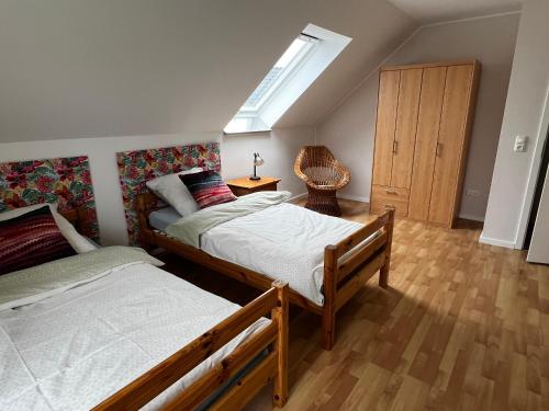 a bedroom with two beds and a skylight at Eifeleule in Hürtgenwald